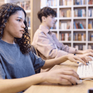 People working at computers in a library.