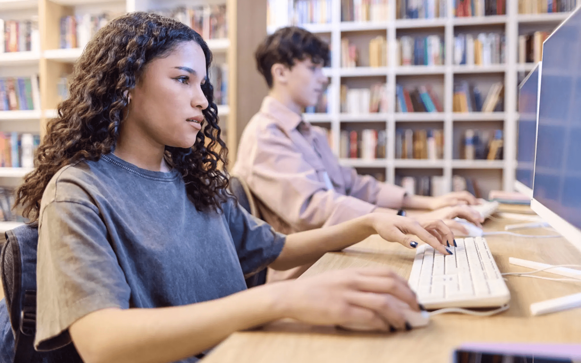 People working at computers in a library.